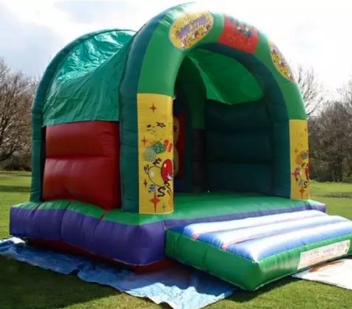 Colorful covered inflatable bouncy castle set up outdoors by Bizi Bouncers UK for bouncy castle hire Barkingside