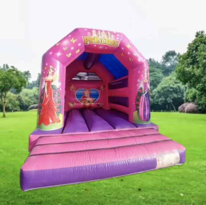 Pink princess-themed bouncy castle set up on grass in Islington park, available for hire from Bizi Bouncers UK.